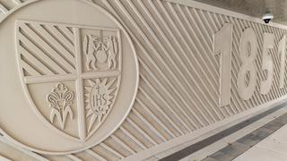 the SJU seal and 1851 inside Post Crossing