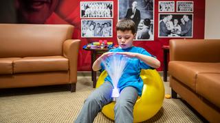 Kinney student in Saint Joseph's autism break room sitting on yellow seat