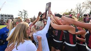Saint Joseph's field hockey team holding championship trophy