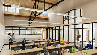 A large indoor multipurpose room filled with children doing activities with teachers