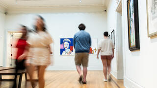 People walking inside Maguire Museum gallery