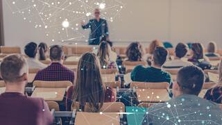Male professor teaching class full of students with AI graphic over top