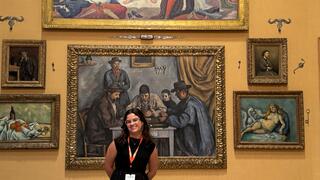 Student stands in front of paintings at Barnes Foundation