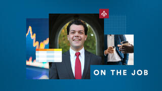 Andrew Haas, BS ’27, with a spreadsheet and cup of coffee