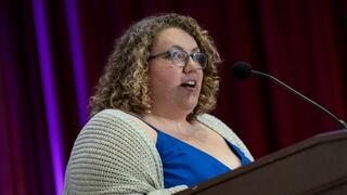 Maddie Marriott speaking at a podium