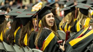 Smiling graduate in regalia