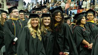 Three smiling graduates