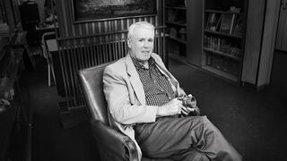 Black and white photo of John R Post seated in a chair