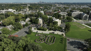 Aerial shot of the Class of 2030 with the city skyline in the back. 
