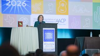 Laura Waite standing at a podium