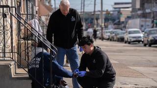 Fr. Peter Clark and a student providing care as part of the ICB's mobile wound care clinic.