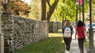 Two female students walking on Saint Joseph's campus