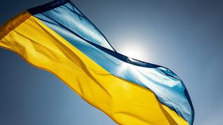 Ukrainian flag against a blue, sunny sky