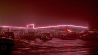 "Pink Line," a photo from Ydeen's series, shows a neon line glowing across an auto shop.