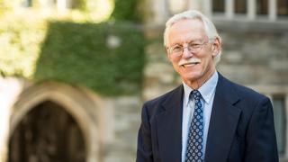 SJU professor Randall Miller, PhD, stands in the Barbelin Hall courtyard.