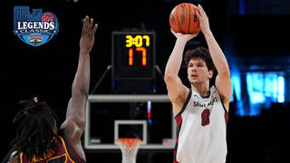 Saint Joseph's basketball player throwing ball across court with opponent in front