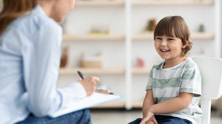 Counselor speaking to young patient in office