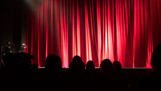 A theater with a red curtain.