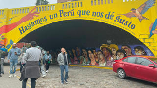 Dr. Heasley strutting down a street embellished with an impressive mural.