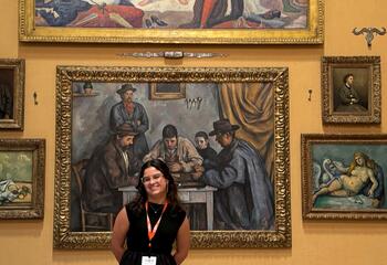 Student stands in front of paintings at Barnes Foundation
