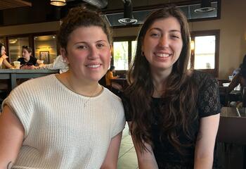 Two female students seated a the campus Starbucks