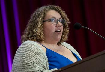 Maddie Marriott speaking at a podium