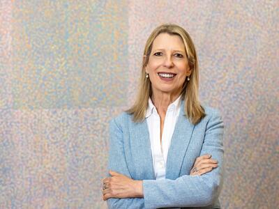 President Cheryl A. McConnell wearing blue blazer and light colored background 