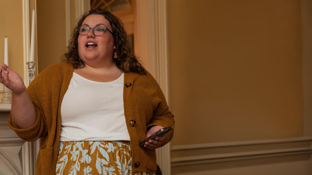 Maddie Marriott speaking at a poetry slam event