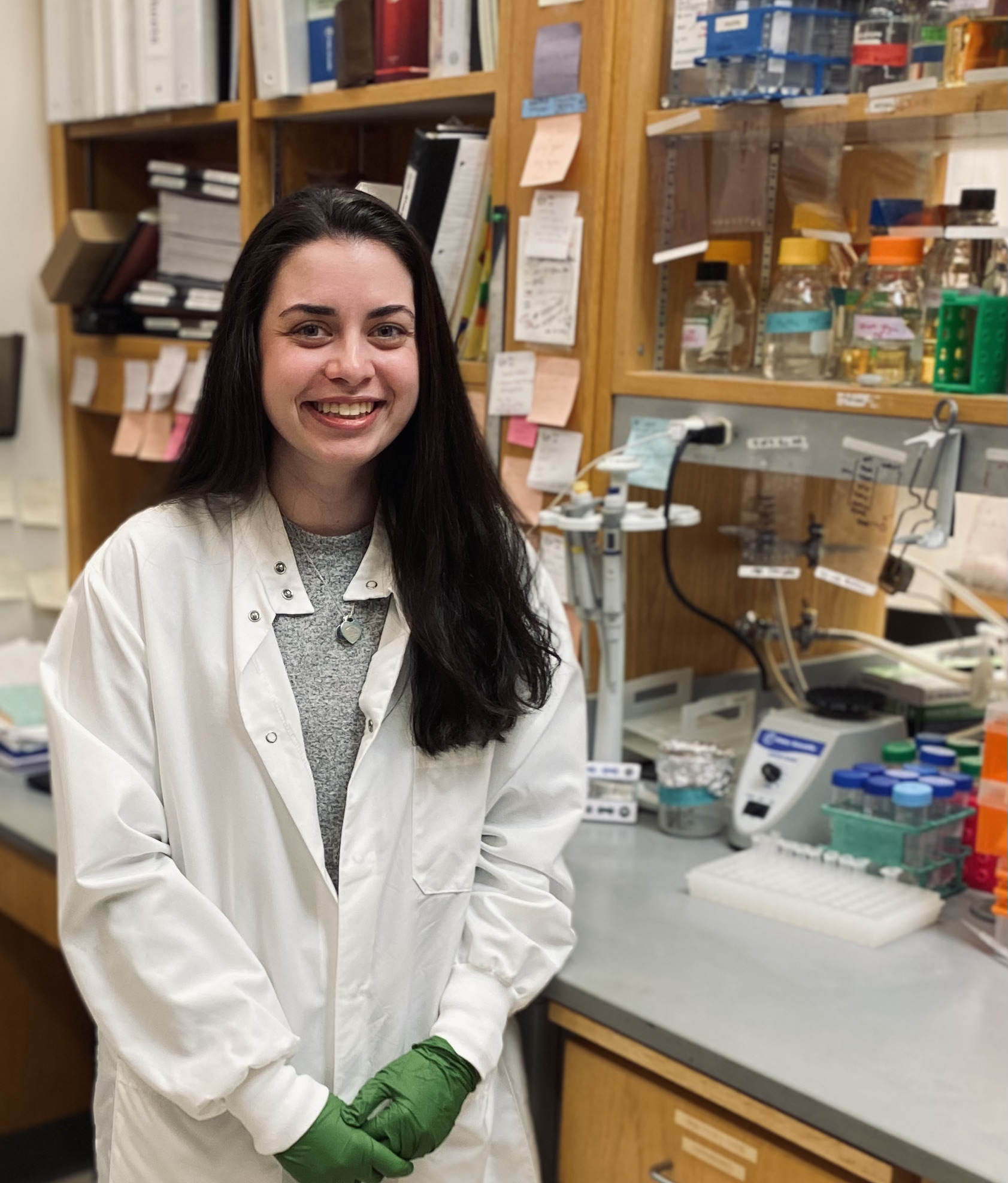 marisa egan wearing a lab coat in the laboratory