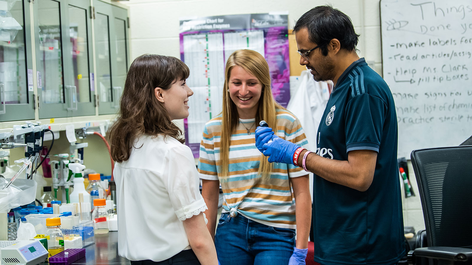 two biology students with professor in lab at saint joseph's university