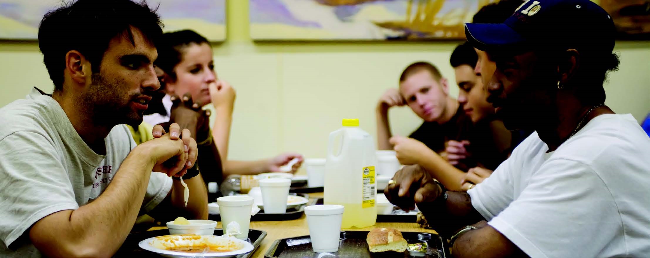 A group of men eating a meal at a table.