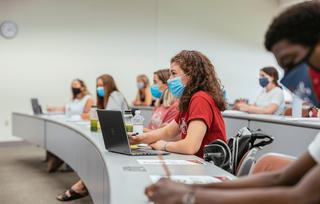 Students in a classroom wearing face masks.