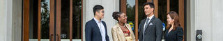 Graduate students outside of Mandeville Hall.