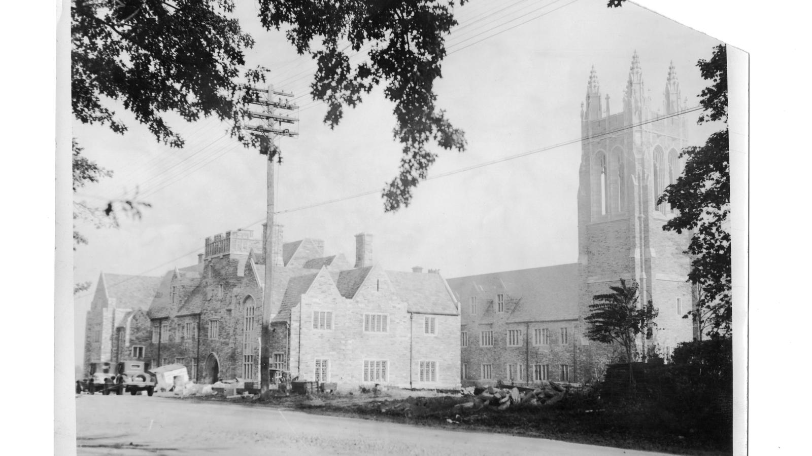 Exterior view of Barbelin building from City Avenue near end of construction with two automobiles in front 1927