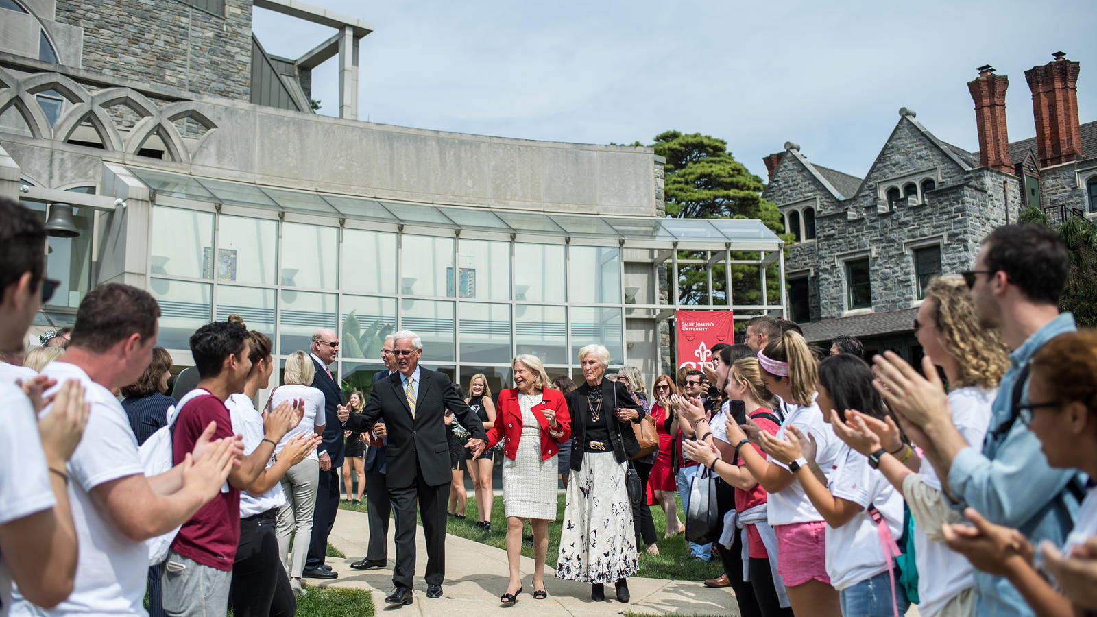 The Maguire family is greeted by campus outside of the Chapel to celebrate their geneousity