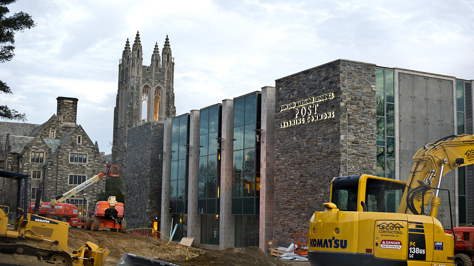 Construction vehicles parked outside the post learning commons