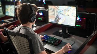 male student playing video game in esports lab