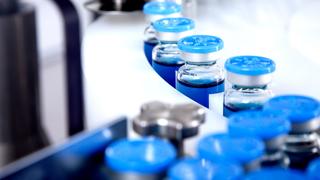 Glass bottles in production in the tray of an automatic liquid dispenser
