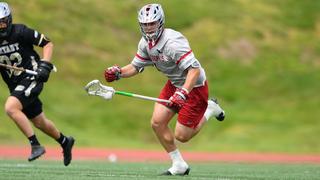 Lacrosse player Zach Cole runs with a lacrosse stick