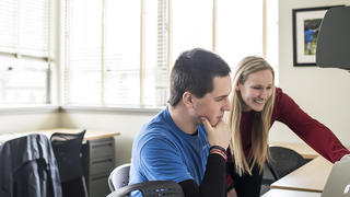 Kinney center staff member working with client at a computer