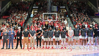 SJU men's basketball team holds a moment of silence before a game.