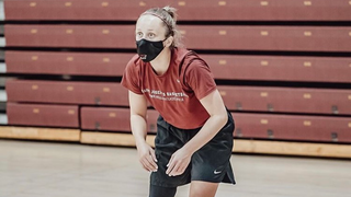Woman basketball player, wearing black face mask