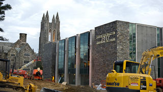 Construction vehicles parked outside the post learning commons