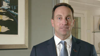 Mark C. Reed, Ed.D., seen from the shoulders up faces straight ahead in a blue tie and white shirt.