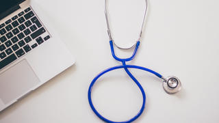 computer and stethoscope on a table