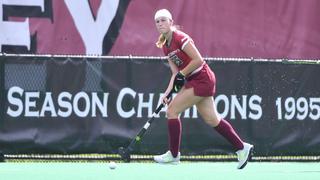Freke Van Tilburg runs with field hockey stick