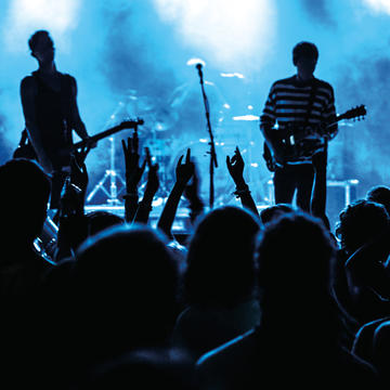 Band performs on stage at concert