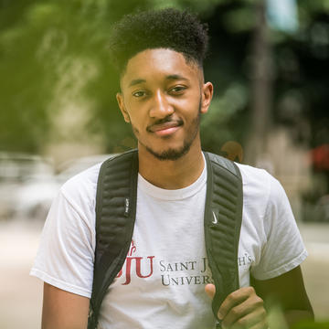 Saint Joseph's University student walking on campus.