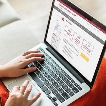 hands typing on a laptop