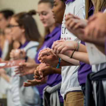 mass attendees hold hands